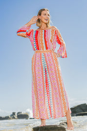Model Riina wearing size 10 of the Moon Bay Cotton Pants in colour Multipink (Pink), from the front, showing the whole outfit