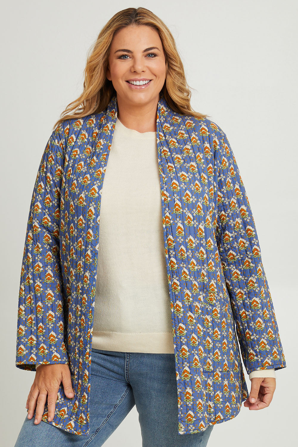 Model Fiona wearing size 16 of the Brighton Beach Reversible Jacket in colour Patchblue (Blue), from the front, cropped image