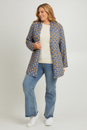 Model Fiona wearing size 16 of the Brighton Beach Reversible Jacket in colour Patchblue (Blue), from the front, showing the whole outfit