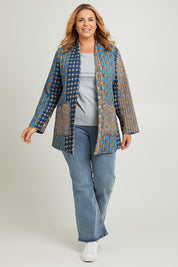 Model Fiona wearing size 16 of the Brighton Beach Reversible Jacket in colour Patchblue (Blue), from the front, showing the whole outfit
