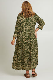 Model Fiona wearing size 16 of the Greenly Beach Dress in colour Green (Green), from the back