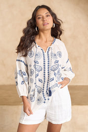 Model Tahnee wearing size 10 of the Whitehaven Beach Cotton Blouse in colour Whiteblue (Blue), from the front, showing the whole outfit