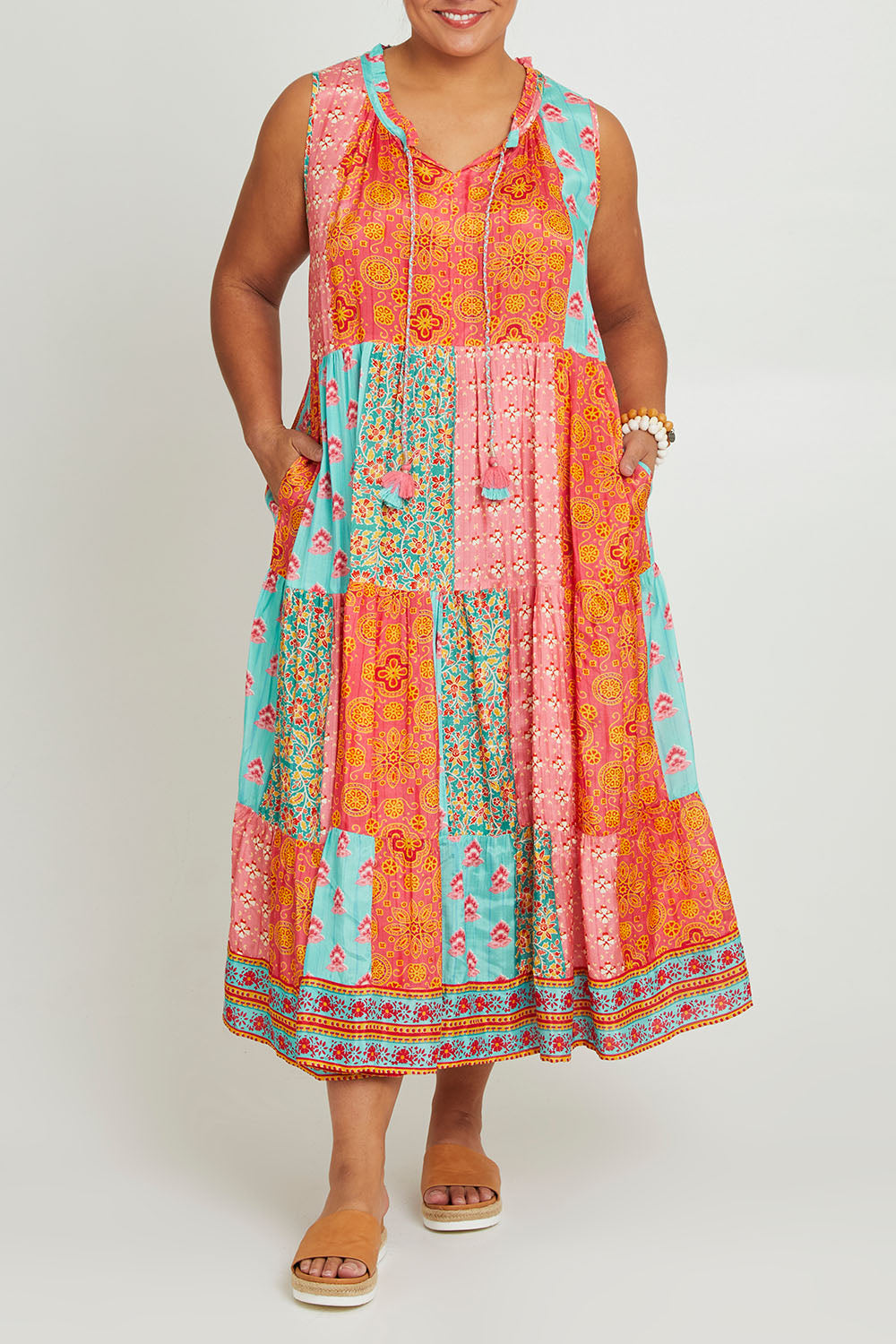 Model Ashleigh wearing size 16 of the Diamond Beach Sleeveless Dress in colour Bright, from the front, cropped image