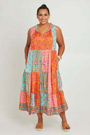 Model Ashleigh wearing size 16 of the Diamond Beach Sleeveless Dress in colour Bright, from the front, showing the whole outfit