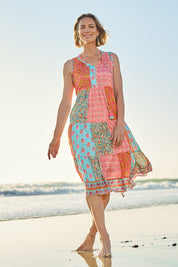 Model Riina wearing size 10 of the Diamond Beach Sleeveless Dress in colour Bright, from the front, showing the whole outfit