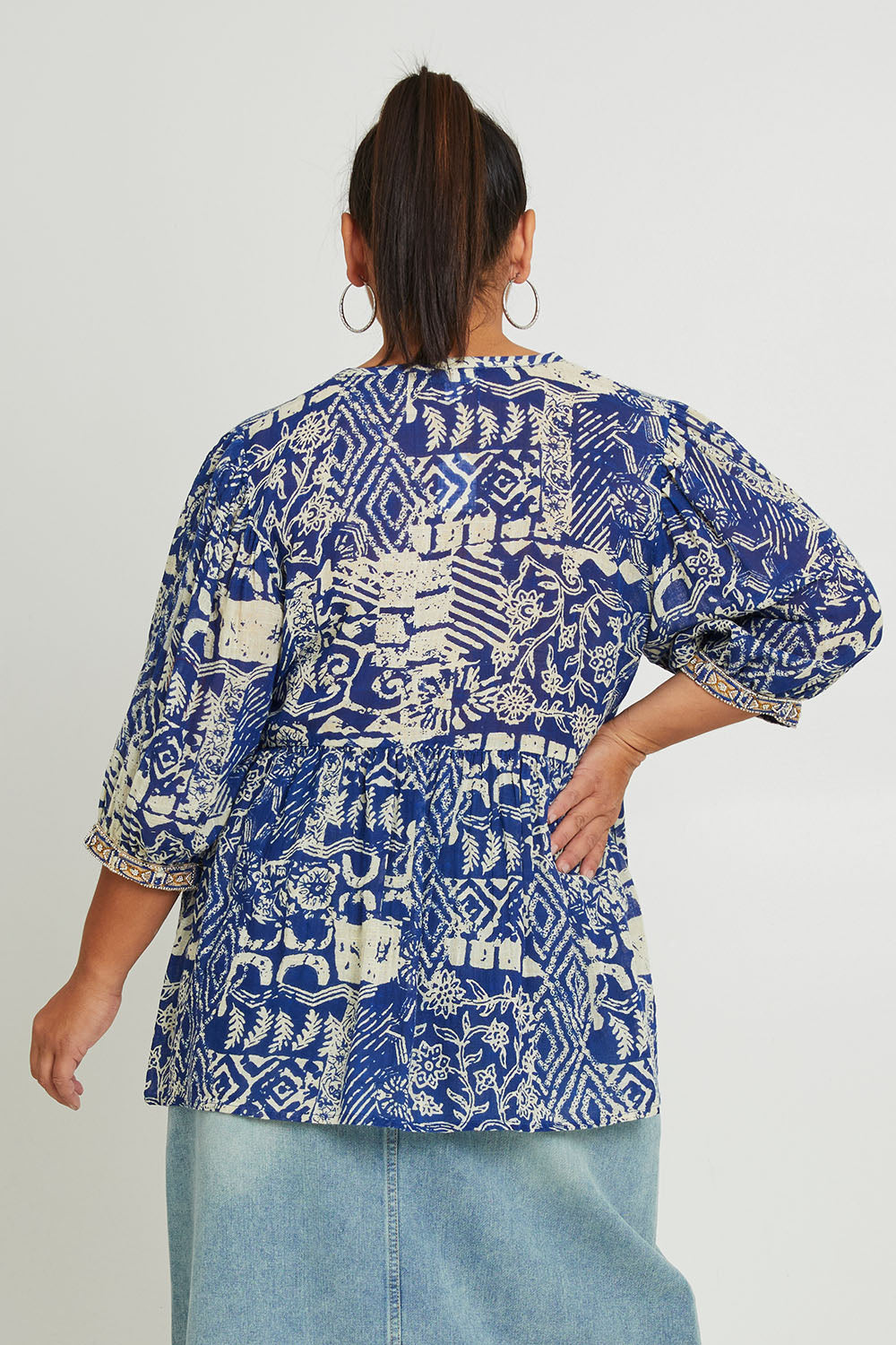 Model Ashleigh wearing size 16 of the Tathra Beach Cotton Top in colour Blue (Blue), from the back