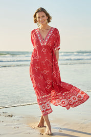 Model Riina wearing size 10 of the Dee Why Beach Cotton Maxi Dress in colour Boldred (Red), from the front, showing the whole outfit