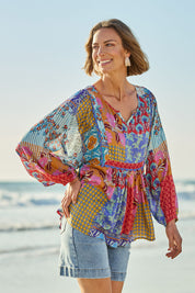Model Riina wearing size 10 of the Burleigh Beach Top in colour Patchmulti, from the front, showing the whole outfit