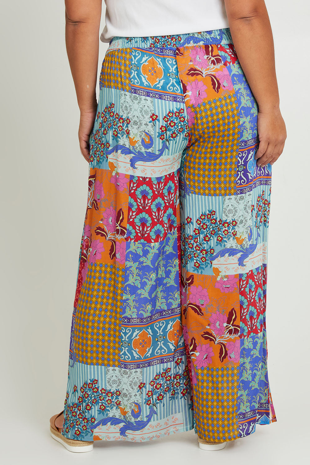 Model Ashleigh wearing size 16 of the Burleigh Beach Pant in colour Patchmulti, from the back
