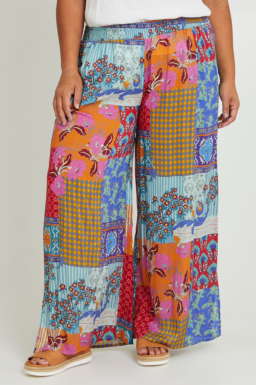 Model Ashleigh wearing size 16 of the Burleigh Beach Pant in colour Patchmulti, from the front, cropped image