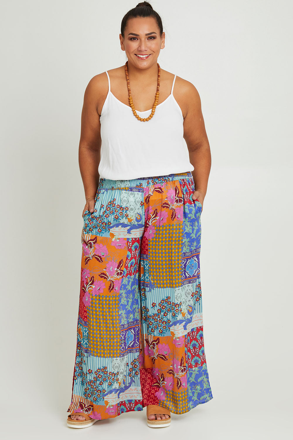 Model Ashleigh wearing size 16 of the Burleigh Beach Pant in colour Patchmulti, from the front, showing the whole outfit