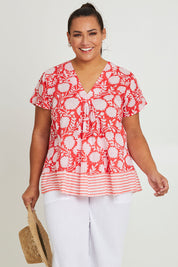 Model Ashleigh wearing size 16 of the Kurrawa Beach Cotton Top in colour Redcoral (Red), from the front, cropped image