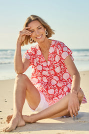 Model Riina wearing size 10 of the Kurrawa Beach Cotton Top in colour Redcoral (Red), from the front, showing the whole outfit