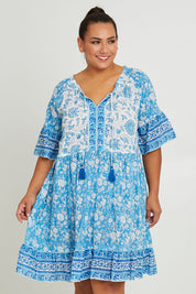 Model Ashleigh wearing size 14 of the Cottesloe Beach Cotton Dress in colour Bluefloral (Blue), from the front, cropped image