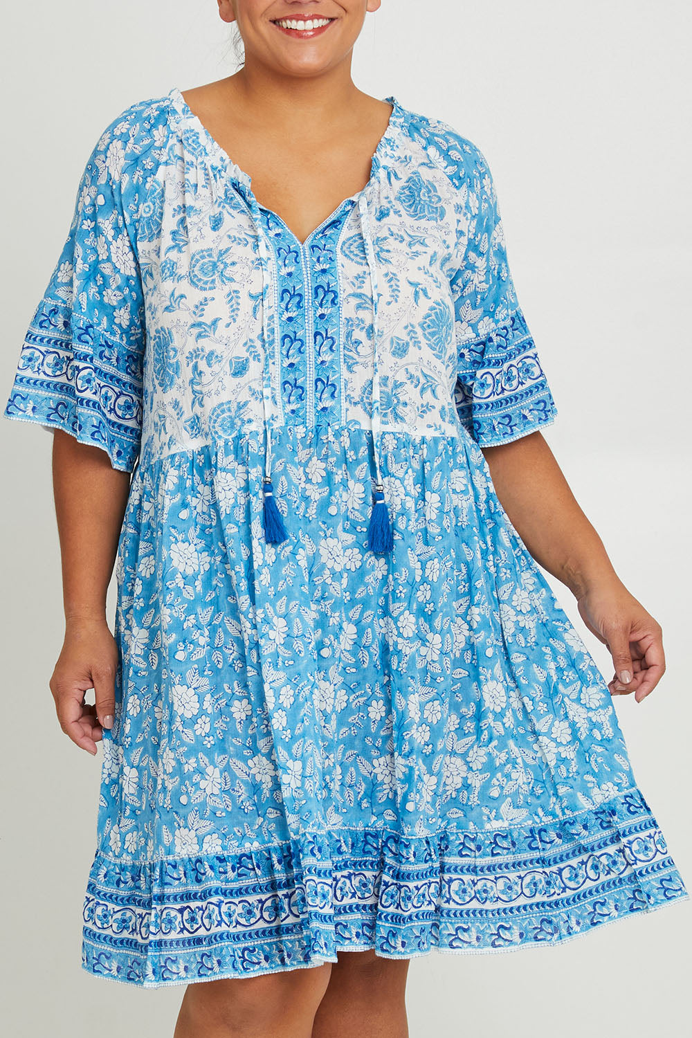 Model Ashleigh wearing size 16 of the Cottesloe Beach Cotton Dress in colour Bluefloral (Blue), from the front, cropped image