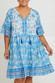 Model Ashleigh wearing size 16 of the Cottesloe Beach Cotton Dress in colour Bluefloral (Blue), from the front, cropped image