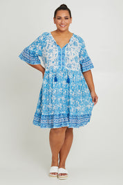 Model Ashleigh wearing size 16 of the Cottesloe Beach Cotton Dress in colour Bluefloral (Blue), from the front, showing the whole outfit