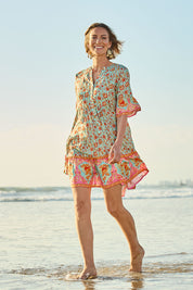 Model Riina wearing size 10 of the Pacific Beach Dress in colour Redmint, from the front, showing the whole outfit