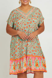 Model Ashleigh wearing size 16 of the Pacific Beach V Neck Dress in colour Redmint, from the front, cropped image