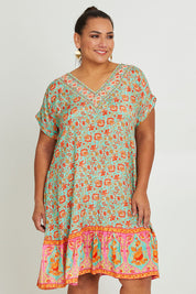 Model Ashleigh wearing size 16 of the Pacific Beach V Neck Dress in colour Redmint, from the front, cropped image