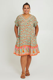 Model Ashleigh wearing size 16 of the Pacific Beach V Neck Dress in colour Redmint, from the front, showing the whole outfit