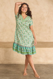 Model Tahnee wearing size 10 of the Pacific Beach V Neck Dress in colour Whitegreen (Green), from the front, showing the whole outfit