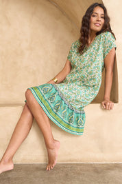 Model Tahnee wearing size 10 of the Pacific Beach V Neck Dress in colour Whitegreen (Green), from the front, showing the whole outfit