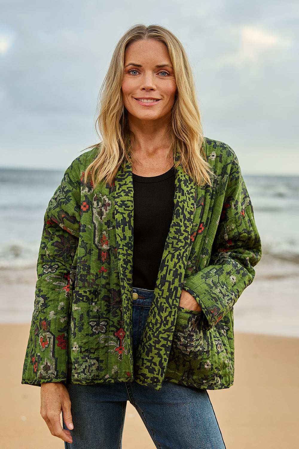 Model Maggie wearing size 10 of the Edith Falls Jacket in colour Aztec (Green), from the front, showing the whole outfit
