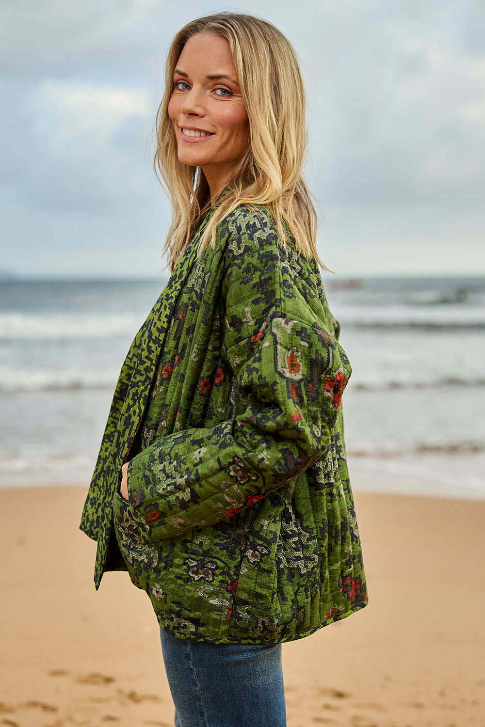 Model Maggie wearing size 10 of the Edith Falls Jacket in colour Aztec (Green), from the front, showing the whole outfit