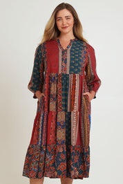 Model Chanel wearing size 16 of the Empress Falls Midi Dress in colour Jumble, from the front, cropped image