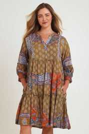 Model Chanel wearing size 16 of the Florance Falls Dress in colour Paisley, from the front, cropped image