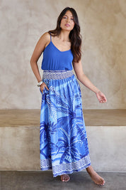 Model Tahneei wearing size 10 of the Palm Cove Long Skirt – Blue in colour Blue, from the front