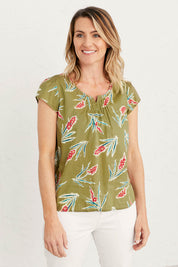 A model wearing the Garden Gate Top in colour Lxiaflower (Green), from the front, cropped image
