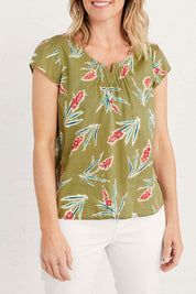 A model wearing the Garden Gate Top in colour Lxiaflower (Green), from the front, cropped image