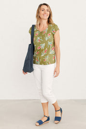 A model wearing the Garden Gate Top in colour Lxiaflower (Green), from the front, showing the whole outfit