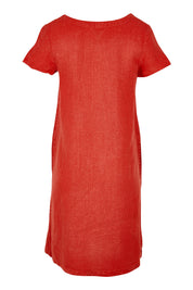Product shot of the Okanum Dress in colour Squash (Red), from the back