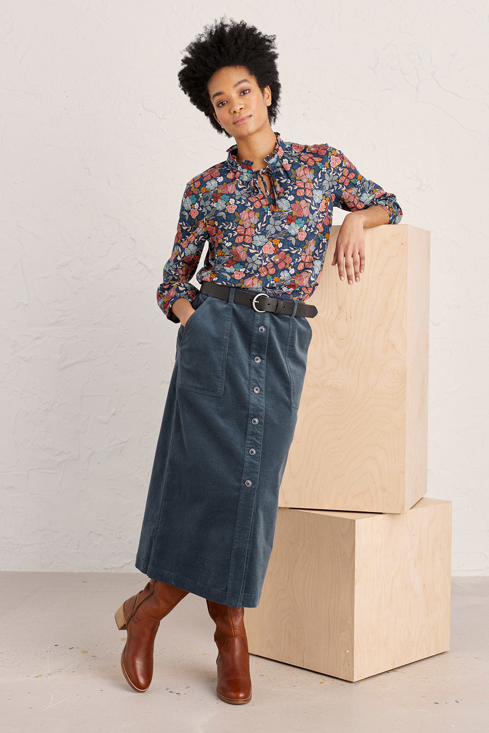 A model wearing the Duality Skirt in colour Sqink (Blue), from the front, showing the whole outfit