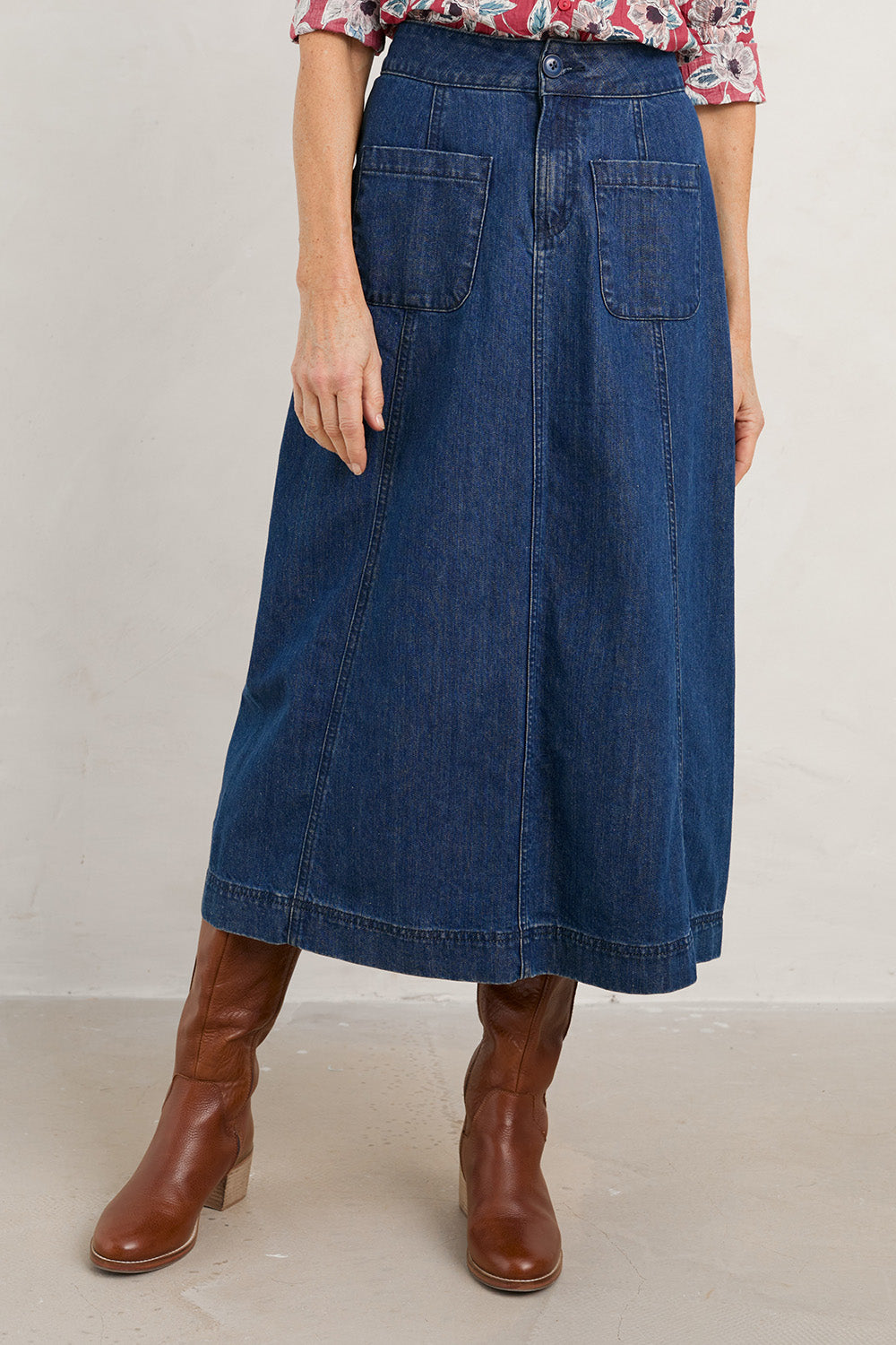 A model wearing the Dusk Journey Skirt in colour Midindigo (Blue), from the front, cropped image