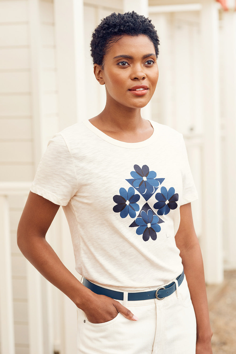 A model wearing the Printing Ink Tin colourShirt - Tiledflora (White), from the front, cropped image