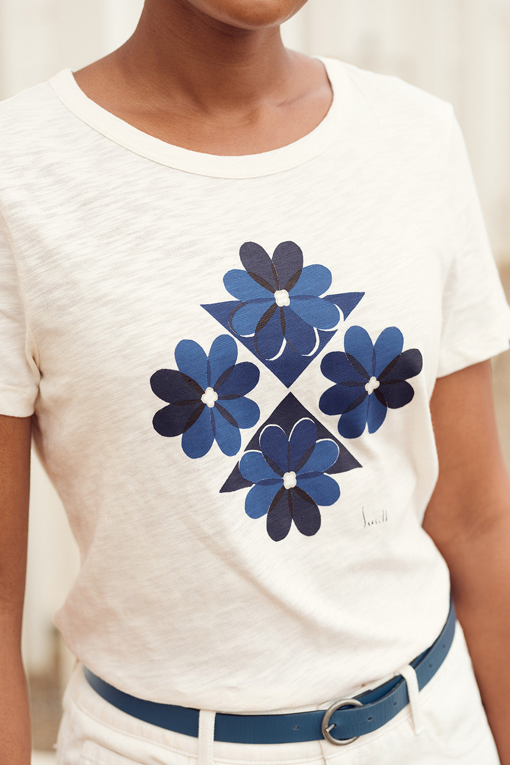 A model wearing the Printing Ink Tin colourShirt - Tiledflora (White), from the front, cropped image