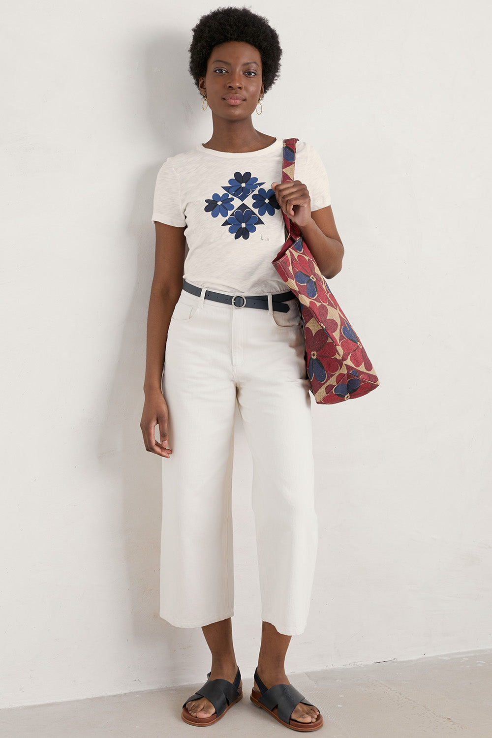 A model wearing the Printing Ink Tin colourShirt - Tiledflora (White), from the front, showing the whole outfit