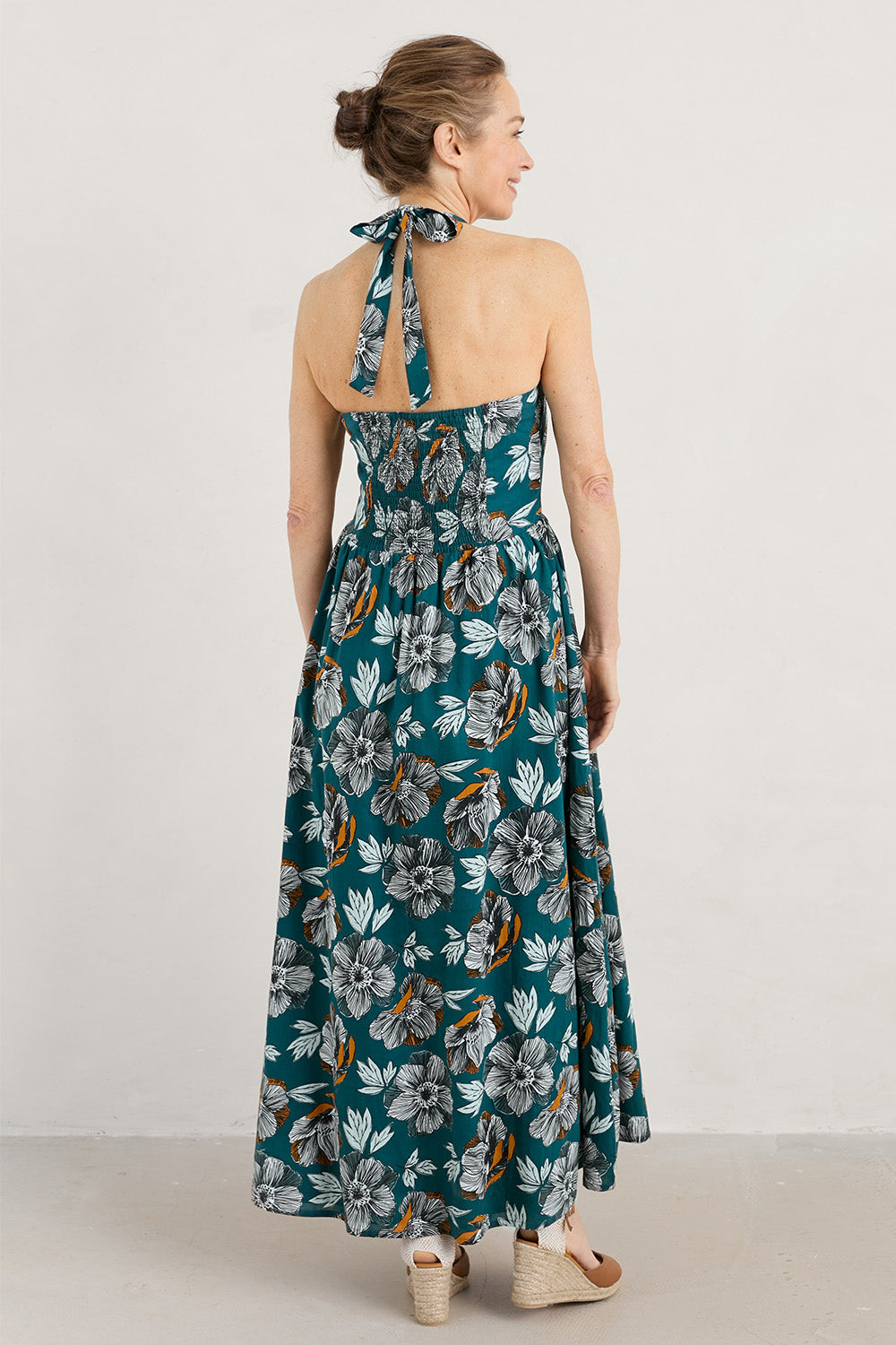 A model wearing the Summer Soul Dress in colour Peony (Green), from the back