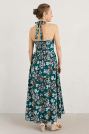 A model wearing the Summer Soul Dress in colour Peony (Green), from the back