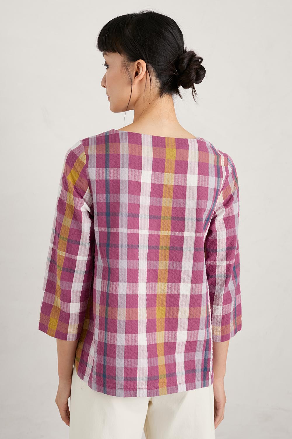 A model wearing the Riding High Top in colour Clover (Pink), from the back