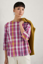 A model wearing the Riding High Top in colour Clover (Pink), from the front, cropped image