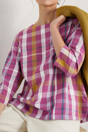 A model wearing the Riding High Top in colour Clover (Pink), from the front, cropped image