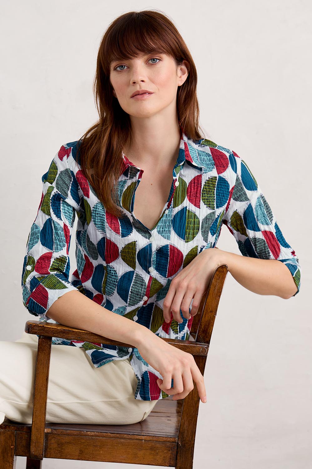 A model wearing the Larissa Shirt in colour Circle (Blue), from the front, cropped image
