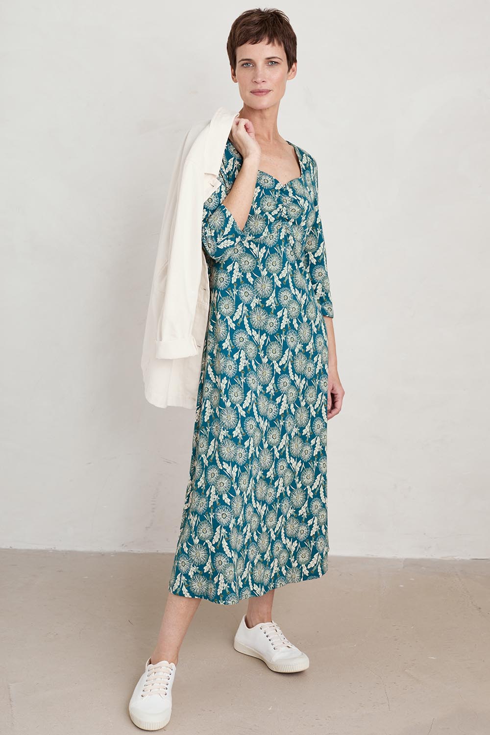A model wearing the Three Quarter Secret Cove Dress in colour Dandelion (Blue), from the front, showing the whole outfit