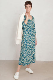 A model wearing the Three Quarter Secret Cove Dress in colour Dandelion (Blue), from the front, showing the whole outfit