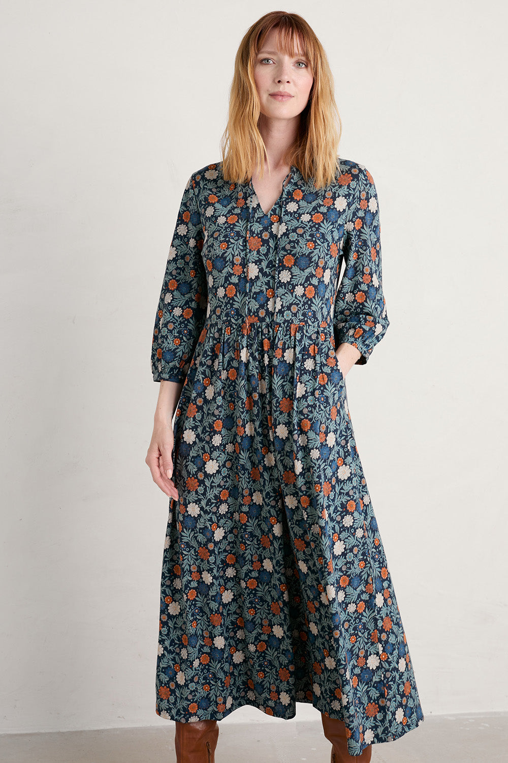 A model wearing the Fox Page Dress in colour Bloom (Blue), from the front, cropped image